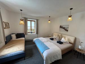 1 dormitorio con 2 camas, ventana y 2 luces en Ferienhaus Dorfschmiede, en Neustift im Stubaital