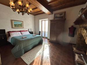 a bedroom with a bed and a chandelier at appartamento storico Valle San Martino di Spoleto in Spoleto