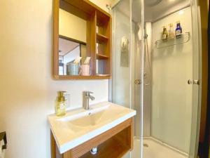a bathroom with a sink and a shower at Fuji Yamanakako Resort Hotel - Vacation STAY 03076v in Yamanakako