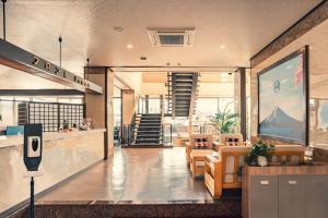 a lobby of a building with chairs and a staircase at Fuji Yamanakako Resort Hotel - Vacation STAY 03076v in Yamanakako