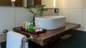 a bathroom with a sink on a wooden table at Westwood Riverside in Munnar +58 photos
