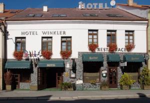 a building with a sign on the front of it at Hotel Solaster Garni in Třebíč