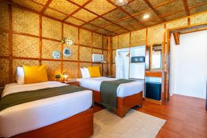Postel nebo postele na pokoji v ubytování Beach Huts El Nido