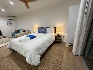 a bedroom with a large bed and a couch at Rainforest Studio with Pool in Palm Cove +28 photos