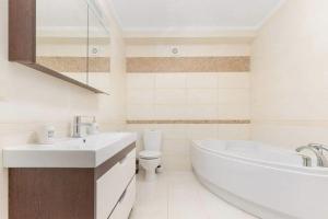 a bathroom with a tub and a sink and a toilet at Сучасна вілла у моря in Odesa +13 photos