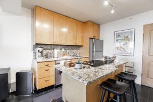 a kitchen with wooden cabinets and a counter top at Condo with Onsite Pool & Hot Tub, Free WiFi & Garage Parking in Vail