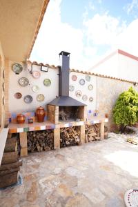 a patio with a wood fired oven on a wall at Casa El Sol in Mota del Cuervo