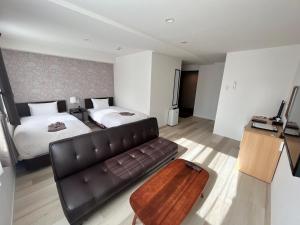 Postel nebo postele na pokoji v ubytování Cozy Inn OTARU