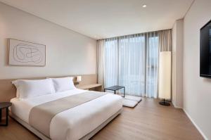 Postel nebo postele na pokoji v ubytování Shilla Stay Plus Iho Tewoo Ocean Front