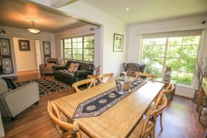 a living room with a wooden table and chairs at Abbeville In Bright in Bright