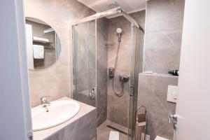 a bathroom with a shower and a sink at Stil Hotel in Bucharest