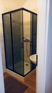 a glass shower in a bathroom with a sink at DH Duomo III apartment in Košice