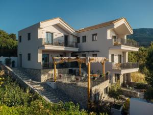 a villa with a view of a building at Trizonia Mare Suites in Trizonia