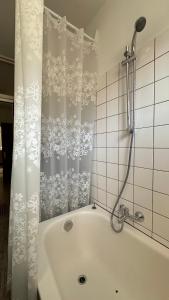a bath tub with a shower curtain in a bathroom at Ferienwohnung Casa Claudia in Liezen