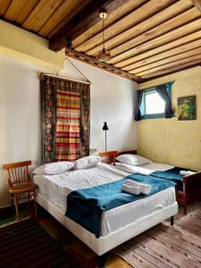 a bedroom with two beds and a window at Hotel Bashinjaghyan in Sevan