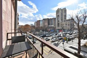 a balcony with a view of a parking lot with cars at Luxe Apartment in the Center of Yerevan 007 in Yerevan