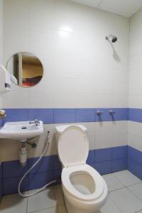 a bathroom with a toilet and a sink at Astrotel Calamba in Calamba