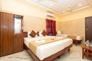Postel nebo postele na pokoji v ubytování Amman Residency - Rameswaram