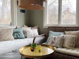 a living room with a couch and a table at 6 person holiday home in HERRäNG in Herräng