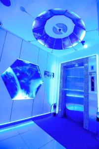 a bathroom with a shower with a blue light at Astrotel Calamba in Calamba