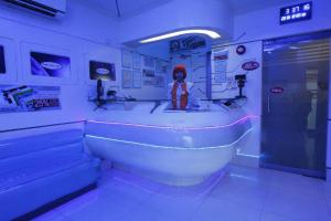 a bathroom with a bath tub with a person in it at Astrotel Calamba in Calamba