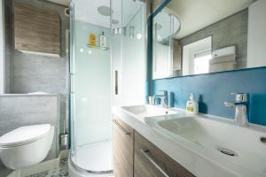 a bathroom with a toilet and a sink and a shower at Le Nid Douillet ~ Confort ~ Parking ~ Terrasse in Saint-Chéron