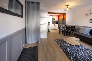 a living room with a couch and a table at Le Nid Douillet ~ Confort ~ Parking ~ Terrasse in Saint-Chéron