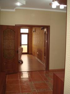 a living room with a door and a tub at Bishkek Residence Apartment in Bishkek
