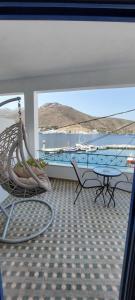a room with a hammock and a view of the ocean at Kalliopis Rooms in Katapola