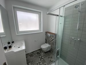 a bathroom with a shower and a toilet and a sink at 3 Sosny Apartments in Tatranska Strba
