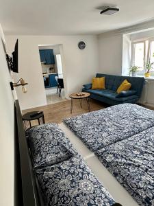 a living room with two beds and a couch at Alpine Echo Apartments in Bovec