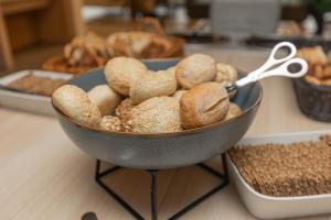 a bowl filled with bread and a pair of scissors at Ansgar Summerhotel in Kristiansand
