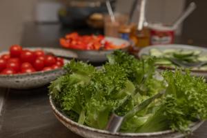 two bowls of lettuce and tomatoes on a table at Ansgar Summerhotel in Kristiansand
