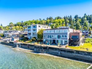 an aerial view of a building next to the water at Waterfront Bliss, 2 BR Apt near Alki Beach in Seattle