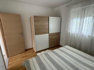 Postel nebo postele na pokoji v ubytování Apartments Elvira