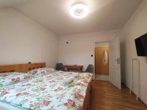 - une chambre dotée d'un lit avec un couvre-lit floral dans l'établissement Ubytování Pohoda, à Třeboň