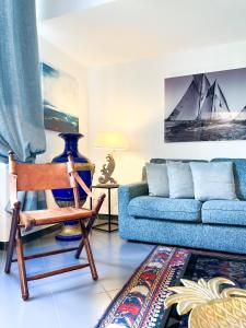 a living room with a blue couch and a chair at ComeCasa Terraced 3 Bedrooms Port View in Santa Margherita Ligure
