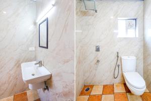 een badkamer met een wit toilet en een wastafel bij FabHotel Perfect Stays in Chennai