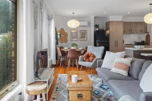 a living room and kitchen with a couch and a table at Gloria of Healesville in Healesville +26 photos