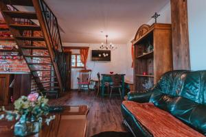 a living room with a couch and a dining room at Brunarica Dežno in Makole