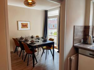 ein Esszimmer mit Tisch und Stühlen und einem Fenster in der Unterkunft Apt Prinz Maximilian - Zentrum - Zimmerprinzen in Oldenburg