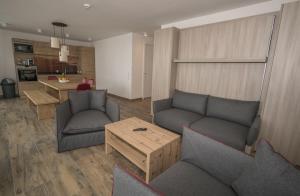 Sala de estar con 2 sofás y mesa en Adler Resort, en Saalbach Hinterglemm
