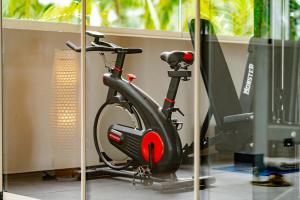 a exercise bike in a room with a monitor at Samawa Living in Paje