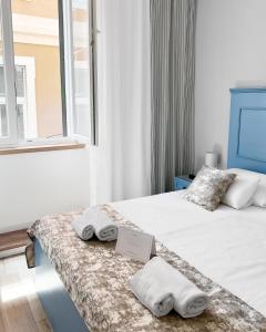 a bedroom with two beds with towels on them at Centrum Luxury Rooms in Šibenik