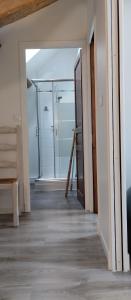 a hallway with a glass shower in a room at Au fil de l'Orge in Saint-Chéron +3 photos