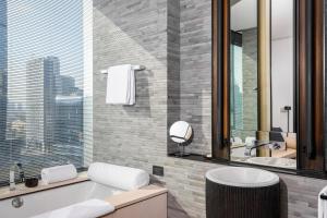 a bathroom with a tub and a sink at The Puli Hotel And Spa in Shanghai