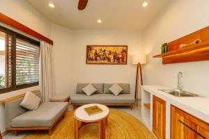 a living room with a couch and a table at Samawa Living in Paje