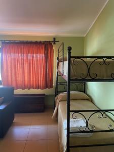 a bedroom with two bunk beds and a window at B&B Casa Vacanze In campagna Immersa nel verde - Serafino Family in Montecalvo Irpino