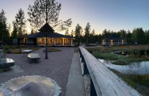 a building with a pavilion in the middle of a park at HUNURIJÄRVI RESORT***** in Härmä