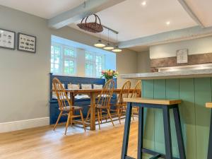 a dining room with a table and chairs at High House Cottage Southwaite in Southwaite